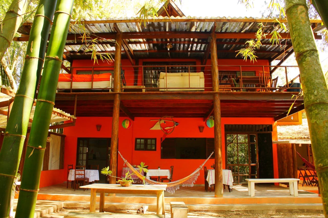 boutique pousada cozy interior with wood textures and tropical plants, natural light