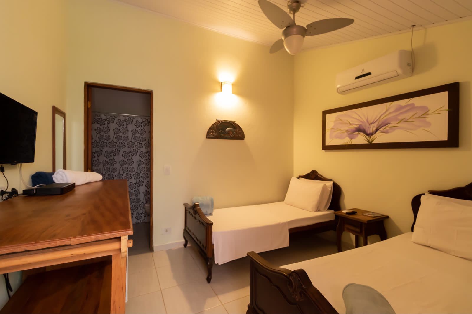 luxury suite with linen sheets and wooden furniture, coastal style